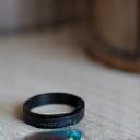 A sleek, minimalist wearable sleep tracker on a bedside table, showing data on a subtle screen.